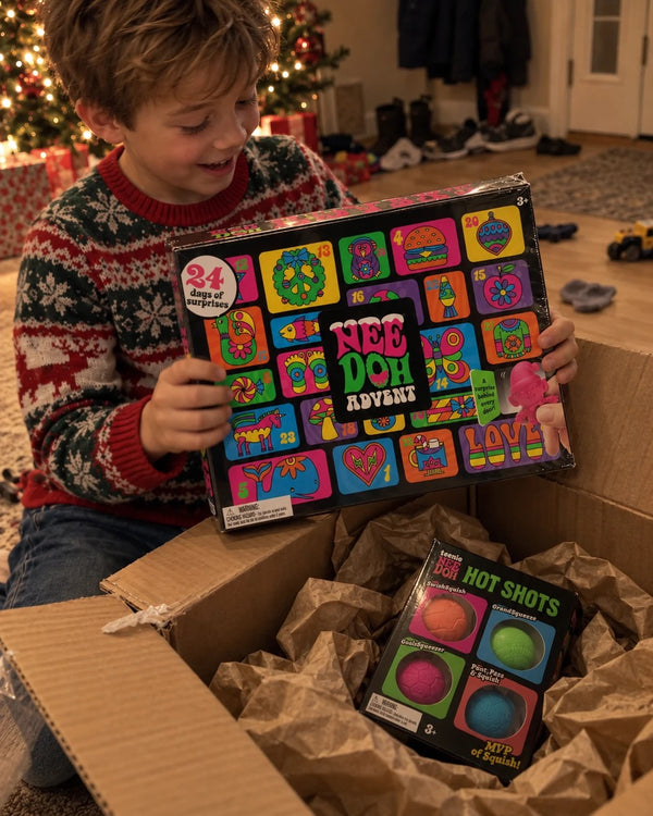Boy unboxing the NeeDoh Advent Calendar from a shipping box