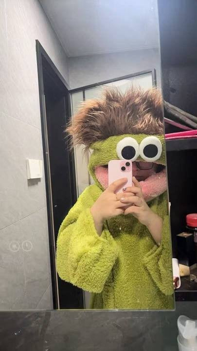 Customer mirror selfie in the green Silly Onesie hood