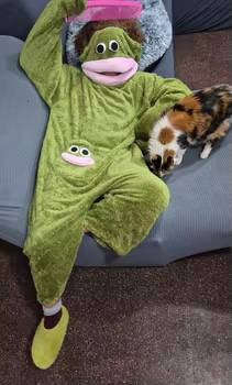 Customer relaxing in the green Silly Onesie next to a cat