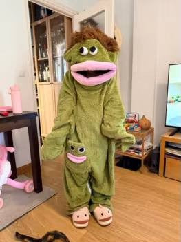 Customer in the green Silly Onesie in the living room